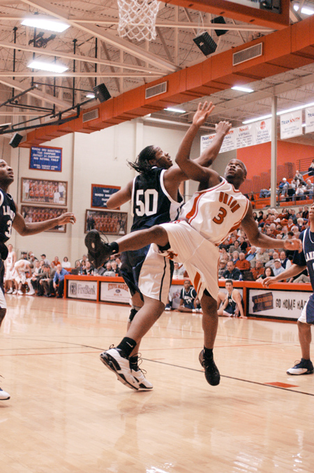 Senior Chima Abakwue (3) battles with a Lambuth player for a rebound. - Photo by Kristen Nicole Sayres