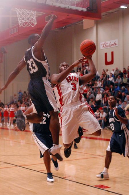 Senior Chima Abakwue (3) goes up for a layup against a leaping Lambuth player. - Photo by Kristen Nicole Sayres
