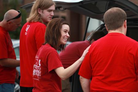 Joy Greene, assistant director of experiential education, talks to the family of a new student before unloading their car during New Student Move-in.  - Photo by Kristi McMurry Woody
