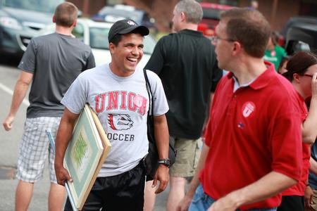Clovis Simas, soccer coach, and Justin Barnard, associate professor of philosophy, laugh together while helping with New Student Move-in.  - Photo by Kristi McMurry Woody