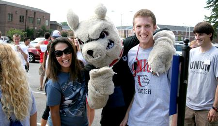 Buster the Bulldog poses with Iris Johnson and TJ Johnson, sophomore computer science major, during a break from helping new students move in. - Photo by Deanna Santangelo