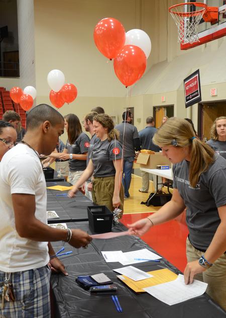 Emily Smith, junior nursing major, helps Ponci Cobb, freshman pre-med major, in filling out registration forms during New Student Move-in.  - Photo by Zac Calvert