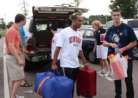 William Murray, senior engineering major, helps Casey Withers, freshman engineering major, move into his dorm in Heritage Complex during New Student Move-in. - Photo by Zac Calvert