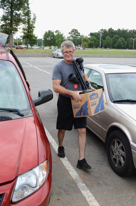 Paul Jackson, professor of Biblical studies, carries a box from a van during New Student Move-in. - Photo by Jacob Moore