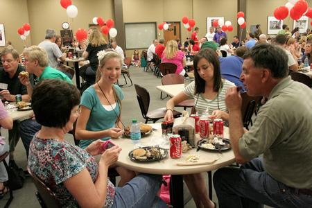 Anna Frederick (center left) talks with Kathryn Feathers and her parents, Cindy and Kenneth Feathers, during the freshmen picnic in the Brewer Dining Hall. - Photo by Deanna Santangelo