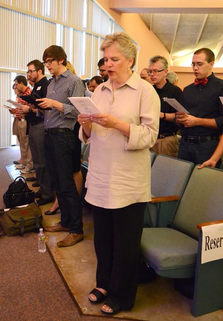 Lanese Dockery, first lady of the university, joins faculty and staff in reciting words of consecration during a time of worship for new students and their families in the GM Savage Memorial Chapel. - Photo by Jacob Moore