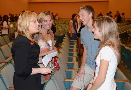 Kimberly Thornbury, dean of students, talks with Katherine Magnuson, Haaken Magnuson, freshman biology major, and Autumn Hitt, freshman piano performance major, after a time of worship for new students and their families. - Photo by Jacob Moore