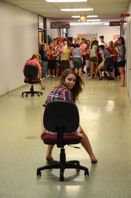 Karli Schumaker, freshman pre-med major, plays in a rolling chair race with her focus group during Focus week. - Photo by Zac Calvert