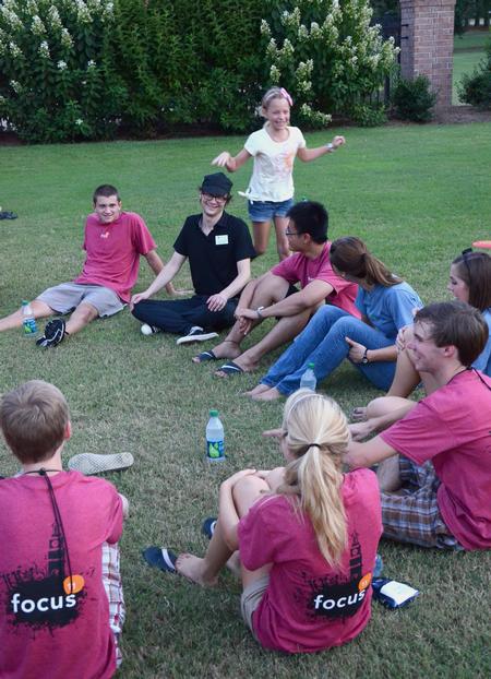 Greg Thornbury, dean of the school of theology and missions, and his daughter join new students in a game of "duck, duck, goose" during the annual ice cream social. - Photo by Jacob Moore