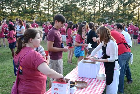 New students are served ice cream by faculty and staff members outside the home of David and Lanese Dockery during the annual ice cream social. - Photo by Jacob Moore