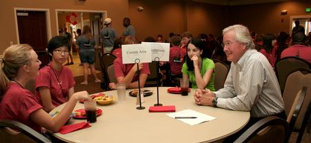 Jim Veneman, assistant professor of communication arts, talks with new students during Dinner with your Department in the Carl Grant Event Center. - Photo by Deanna Santangelo