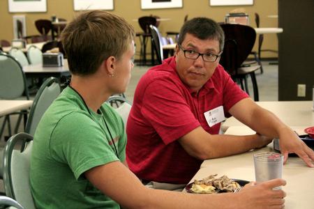 Andrew Tiger, professor of management, talks with Noah Moyers, freshman business major, during Dinner with your Department in the Carl Grant Event Center. - Photo by Deanna Santangelo