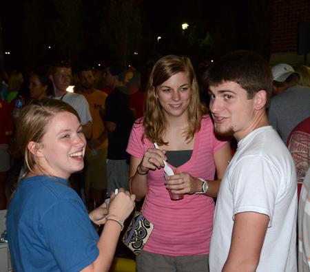 Julia Marshall, junior special education major, Sarah Welch, sophomore nursing major, and Justin Goodson, sophomore English major, talk together during the Howdy Party. - Photo by Jacob Moore
