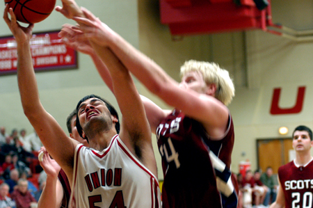Freshman center Ben Frederick (54) grabs the rebound away from a Lyon College player.   - Photo by Jonathan Blair