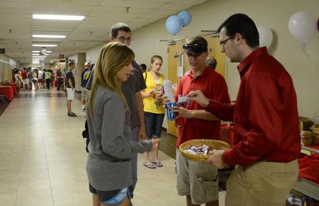 Ryan Griffin, staff assistant, hands out snacks to the incoming freshman class at the Student Activity Fair. - Photo by Ebbie Davis