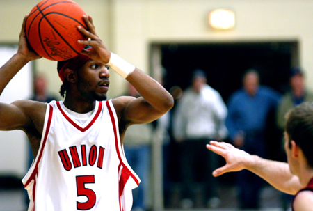 Freshman guard Marcus Cooper (5) looks over the defense during the Union game with Lyon College. - Photo by Jonathan Blair