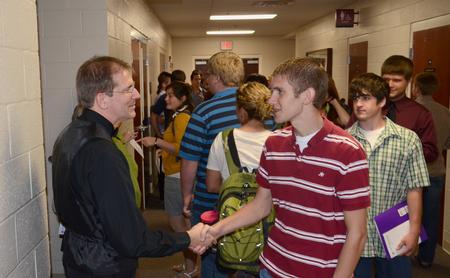 David Dennis, professor of music, shakes hands with Logan Brasher, sophomore vocal music education major, after a faculty recital in Hartley Hall. - Photo by Jacob Moore