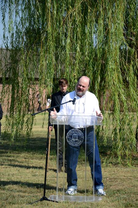Lee Benson, professor of art and department chair, prays at the memorial service held in honor of the September 11 terrorist attacks for the 10 year anniversary of the attacks. - Photo by Ebbie Davis