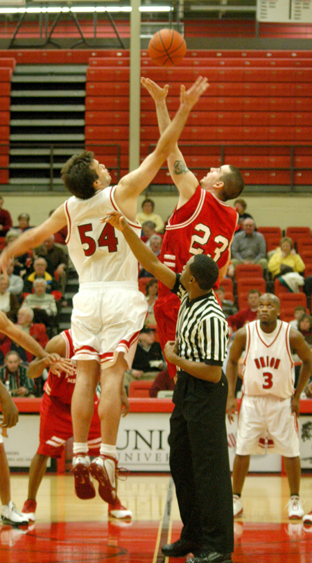 Freshman center Ben Frederick (54) jumps for the opening tip against a Martin Methodist player.  Union won the game 68-65 in overtime. - Photo by Courtney Ross