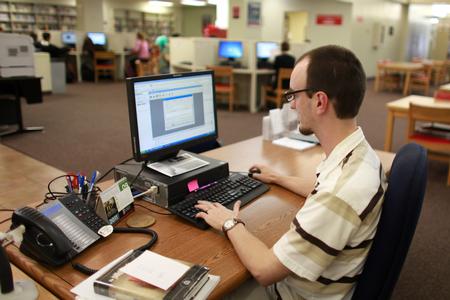Stephen Mount, interlibrary loan and reserves coordinator, works in the Emma Waters Summar Library. - Photo by Kristi McMurry Woody