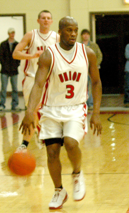 Senior guard Chima Abakwue (3) brings the ball down the floor in Union's 68-65 OT win over Martin Methodist.  Matt Trammell (35) follows close behind. - Photo by Courtney Ross
