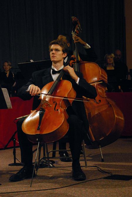 Griffin Browne plays the cello along with the orchestra at the music department's presentation of "Sounding through the Centuries" during the KJV400 festival: Legacy and Impact.  - Photo by Anne Richoux