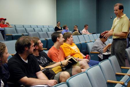Sean Evans, chair of the department of political science, talks to a group of Union students prior to Matthew Anderson's lecture.  - Photo by Anne Richoux