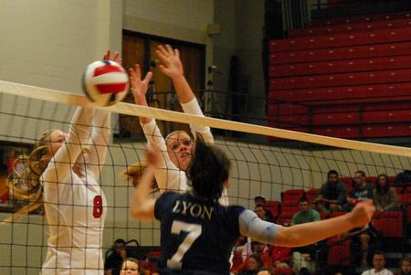 Emmie Moroski and Anna Sims defend the net against an opposing Lyon player. The Lady Bulldogs won the match 3-0. - Photo by Anne Richoux