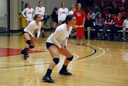 Lydia Wright and Jami Humphries prepare as an opposing Lyon College player serves the ball across the net.  - Photo by Anne Richoux