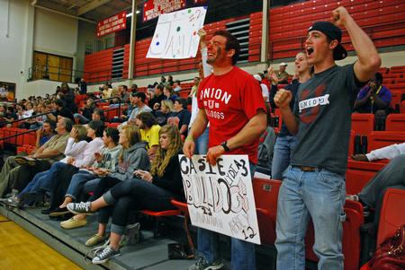 Senior engineering majors, Thomas Drury (left) and Ryan Substad, cheer after the Lady Bulldog Volleyball team scores against Lyon College.  - Photo by Anne Richoux