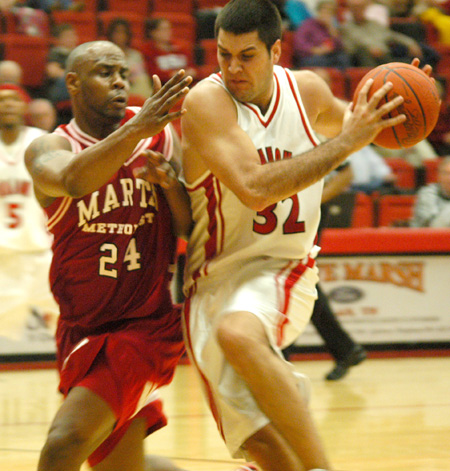Junior forward Bruno Martinessi (32) drives to the basket against a Martin Methodist defender. - Photo by Courtney Ross