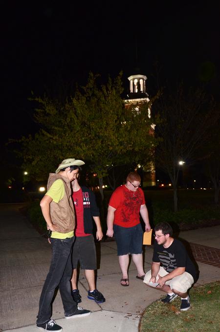Casey Mack, Beau Fant, Kyle Dwyer, and Stephen Charlton brainstorm on where a clue might be on campus during the 7th annual Residence Life Treasure Hunt.  - Photo by Zac Calvert
