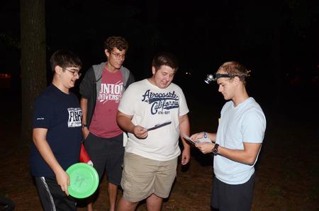 Stephen Clement, James Clary, and Beau Rinker receive a clue from Justin Boggs during the 7th annual Residence Life Treasure Hunt. - Photo by Zac Calvert