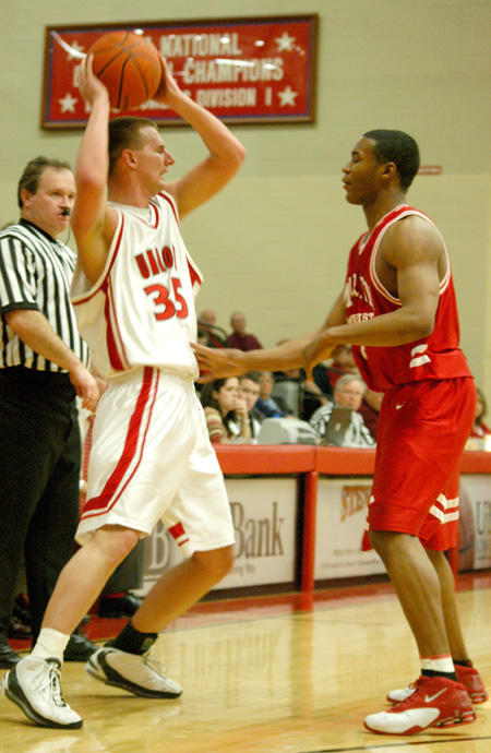 Sophomore guard Matt Trammell (35) looks over the Martin Methodist defense. - Photo by Courtney Ross