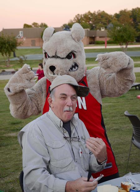 Buster the bulldog goofs off with the father of Travis Cross, sophomore physical science major, at the Make-a-wish cookout during Family Weekend.  - Photo by Zac Calvert