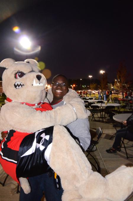 James Barbee, junior elementary education major, holds Buster the bulldog during the Make-a-wish cookout for Family Weekend.   - Photo by Zac Calvert
