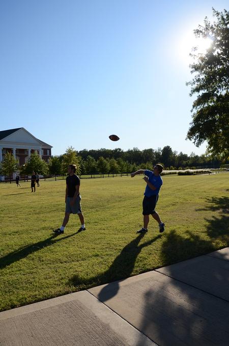 Nathan Foster, freshman nursing major, and Josh Graves, freshman sport management major, practice flag football out on the Great Lawn.  - Photo by Zac Calvert
