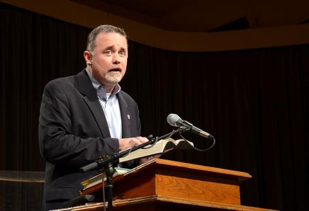 Todd Brady, special assistant to the president for university relations, reads scripture during Family Weekend chapel. - Photo by Jacob Moore