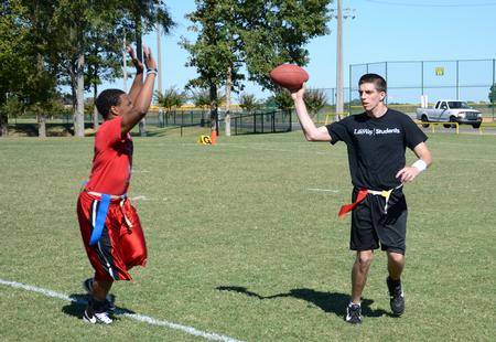 David Virgin, sophomore accounting major, prepares to pass a football during an intramural game on Family Weekend. - Photo by Jacob Moore
