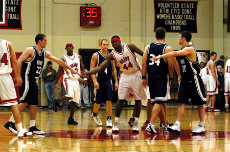Pierry Valmeria (44) and the rest of the Union Bulldogs greet their opponents, Berry College, before a home contest. - Photo by Jonathan Blair