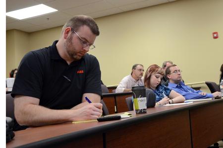 Guests at the "Culture and Crisis" Town and Gown lecture series listen as Andrea McDaniel speaks. - Photo by Anne Richoux