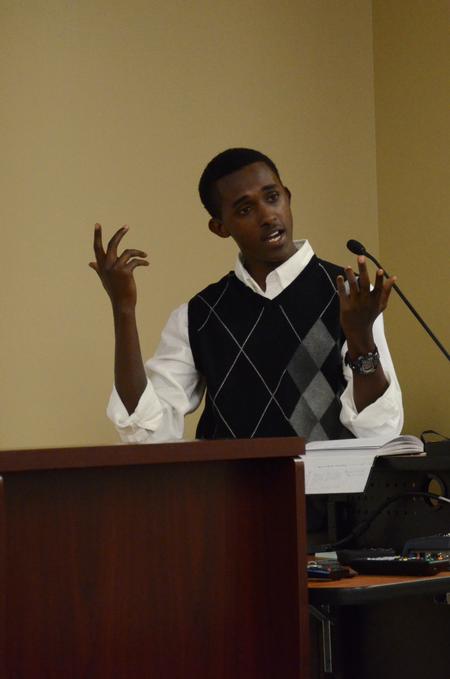 Denis Bisangwa, freshman business adminstration major, talks about his life in Rwanda and introduces the movie As We Forgive during the "Culture and Crisis" Town and Gown lecture series.  - Photo by Anne Richoux