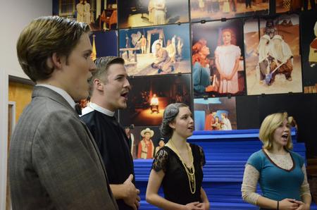 Peter Riggs, David Conway, Aubrey Swanson, and Lori Landon warm up prior to the theater department's performance of "The Importance of Being Earnest." - Photo by Anne Richoux