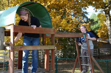 Sarah Bostic, freshman nursing major, and Bri Hansen, senior social work major, prepare to paint a playground at Pleasant Plains Baptist Church in Jackson during Campus and Community Day. - Photo by Jacob Moore