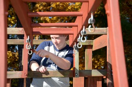 Bri Hansen, senior social work major, paints a playground at Pleasant Plains Baptist Church in Jackson during Campus and Community Day. - Photo by Jacob Moore
