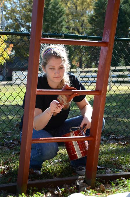Sarah Bostic, freshman nursing major, paints a playground at Pleasant Plains Baptist Church during Campus and Community Day. - Photo by Jacob Moore