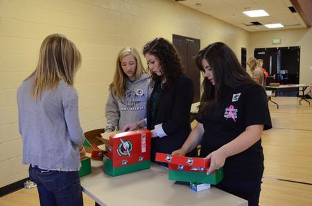 Students help pack Operation Christmas Child boxes during Campus and Community Day.  - Photo by Anne Richoux