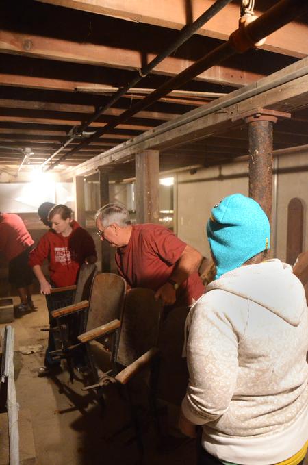 Students help Frank Murchison, member of the historical society at Bemis Mill Village Museum, move old furniture and clean at the Bemis Mill Village Museum during Campus and Community Day.  - Photo by Zac Calvert