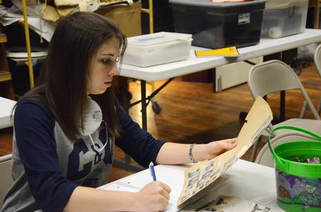 Caitlin Roach, senior history major, helps archive documents and photos at the Bemis Mill Village Museum, during the history department's service project on Campus and Community Day.  - Photo by Zac Calvert