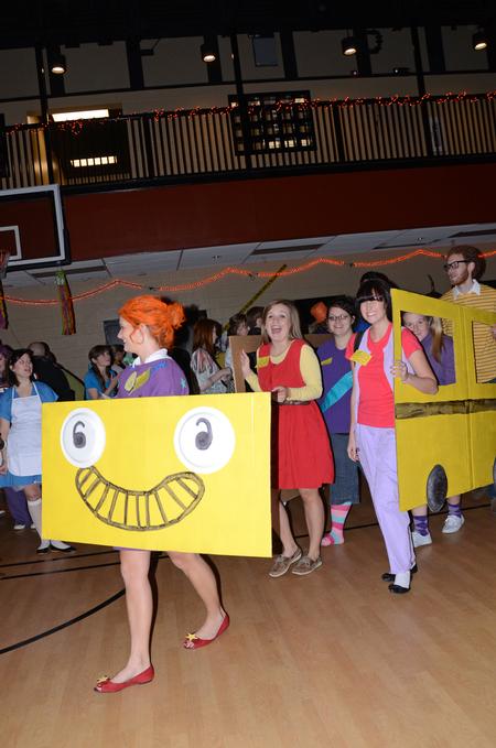 Students walk into the Bowld Student Commons gym for Costume Coffee House dressed up as characters from the television show, The Magic School Bus.  - Photo by Anne Richoux